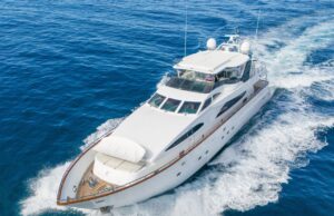 Amazing Benefits of Reupholstering a Boat Every Owner Should Know White luxury motor yacht cruising through deep blue ocean, creating a frothy wake.