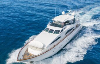 Amazing Benefits of Reupholstering a Boat Every Owner Should Know White luxury motor yacht cruising through deep blue ocean, creating a frothy wake.