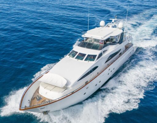 Amazing Benefits of Reupholstering a Boat Every Owner Should Know White luxury motor yacht cruising through deep blue ocean, creating a frothy wake.